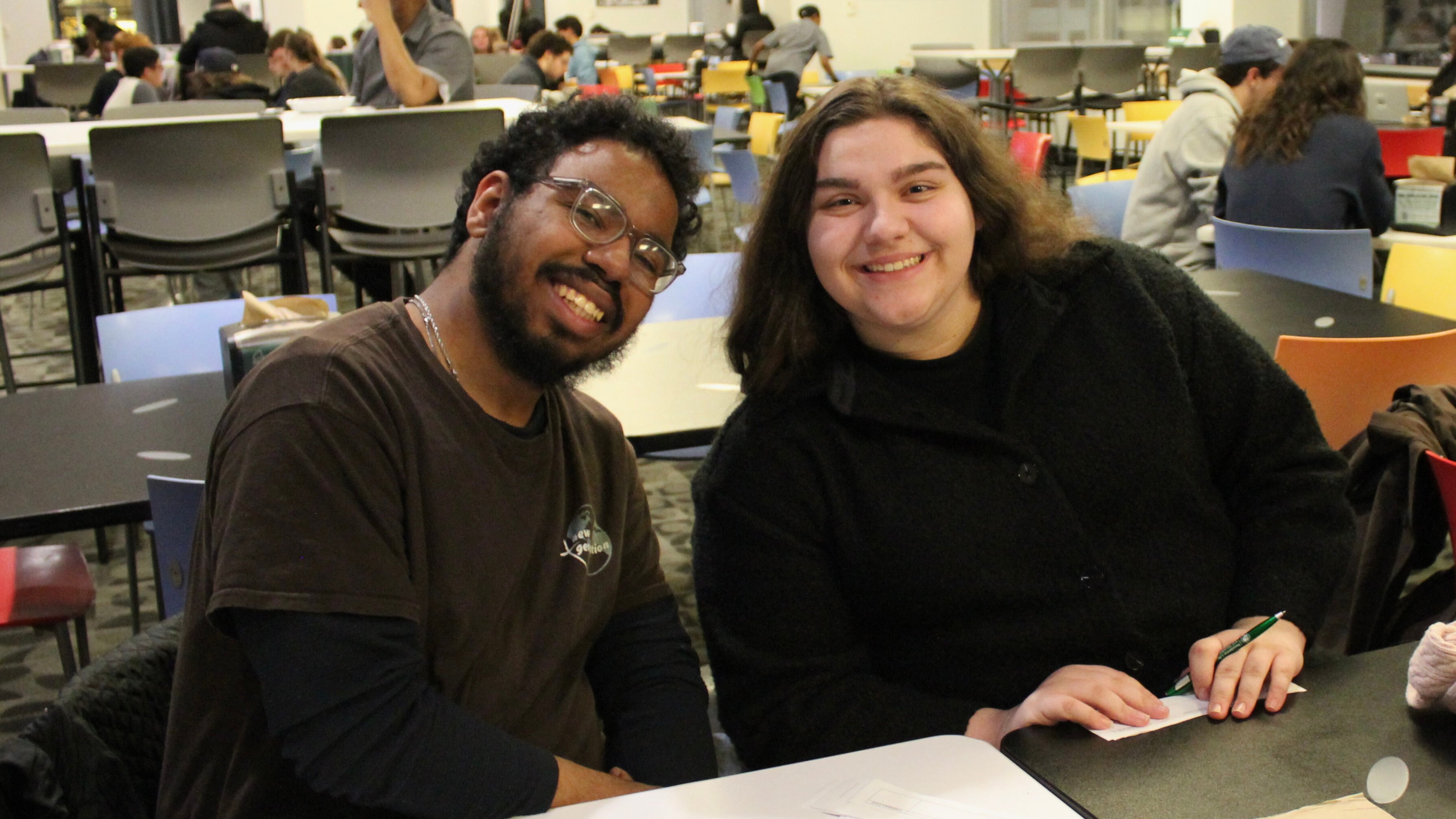 Students Yadiel Mercado, left, and Christina Arrichi pose while playing a round of “pop culture moments” trivia in Viking Marketplace 