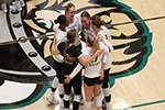 CSU women's volleyball huddled together