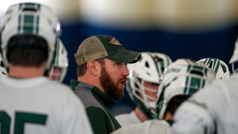 CSU Lacrosse coach Andy German inside the huddle with his team