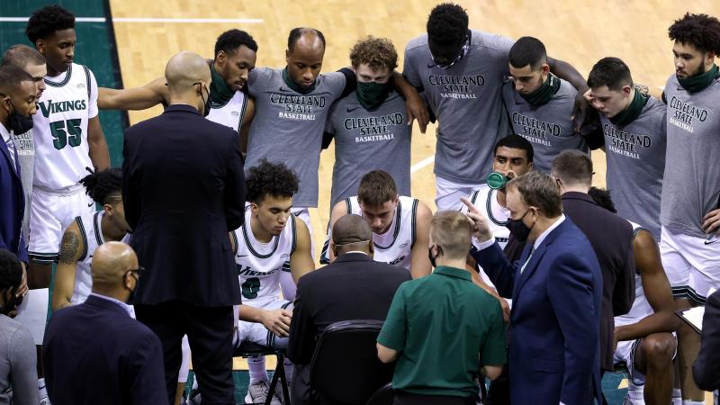 Cleveland State men's basketball huddles around head coach Dennis Gates in game this season. 