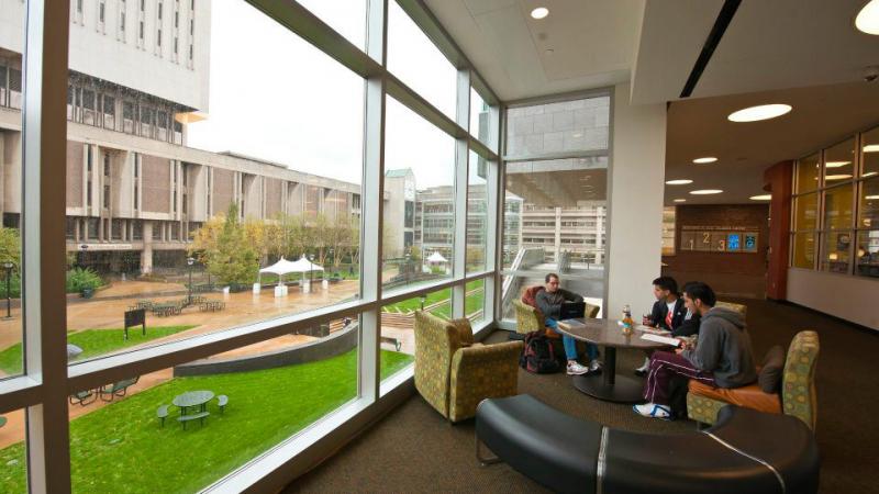 Students sit in the Student Center prior to the pandemic with the Michael Schwartz library in the background.