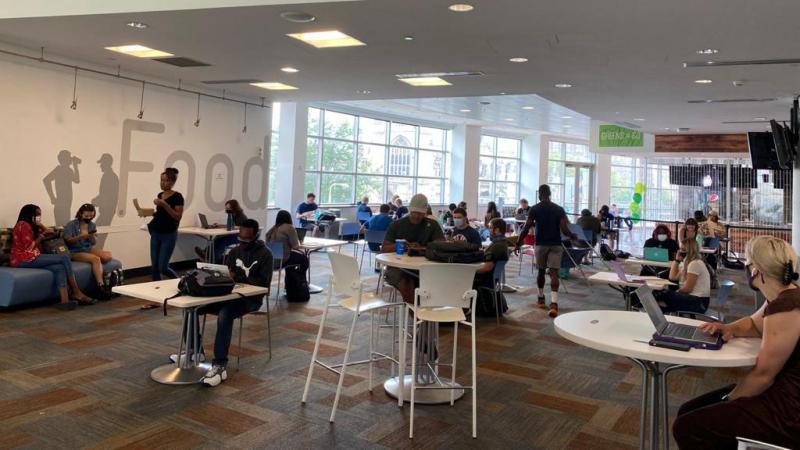 Students sitting around the dining areas in student center