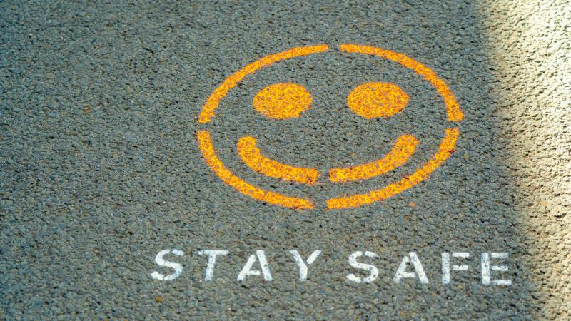 stay safe smiley face on a road