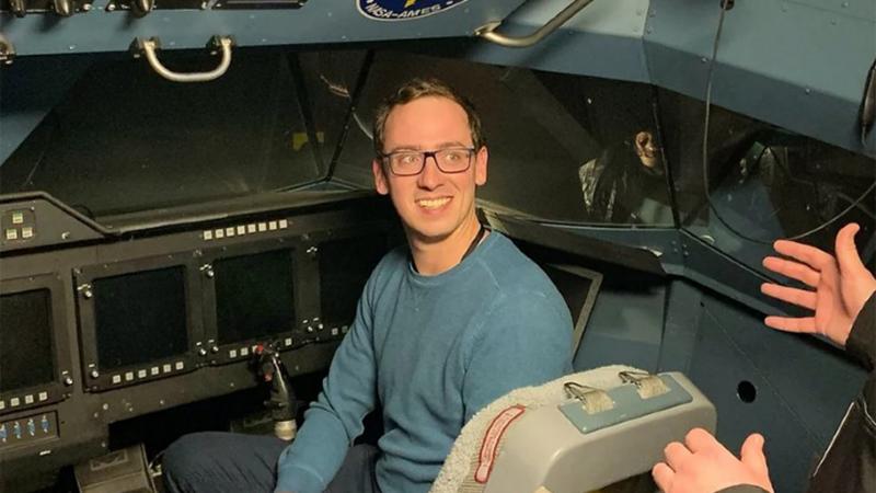 Professor Pedro Gerum, a member of the CSU Department of Operations and Supply Chain Management, sits in the cockpit of a NASA spaceship in 2019.