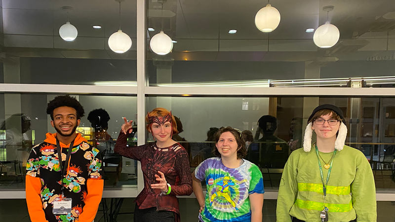 Four CSU students attending VikeCon in themed outfits. 
