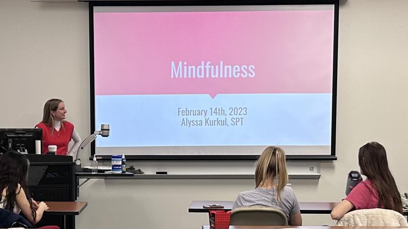 Graduate student Alyssa Karakul looking at the first slide of her presentation, "Mindfulness."