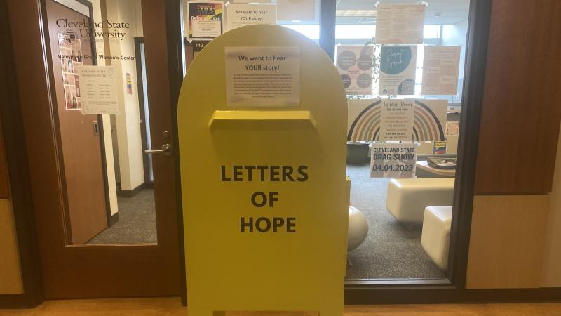 A yellow mailbox outside of CSU's Women's Center with the words "Letters of Hope" written across it.