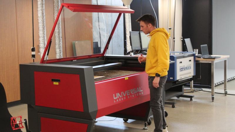 Shane Mussara uses a laser engraver