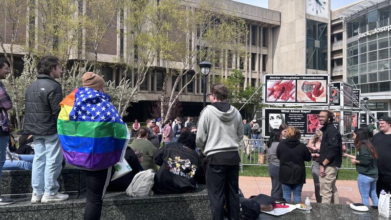 student protests face pro-life signs