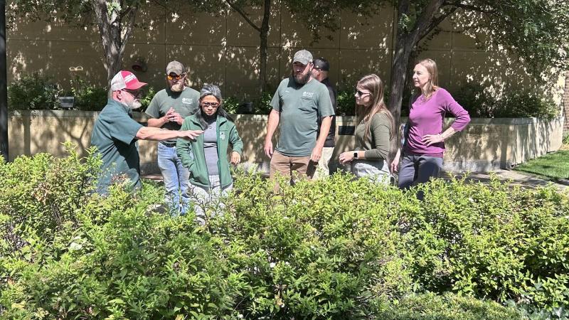 Tim Joseph explaining spirea bushes to the nature walk attendees.