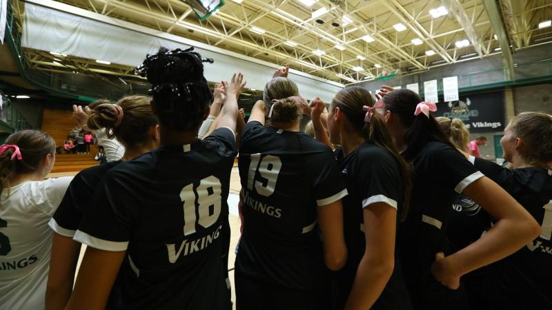 CSU volleyball in a team huddle 