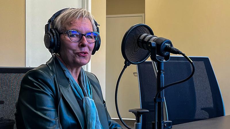 CSU President Laura Bloomberg, Ph.D. sits in front of a microphone for an interview.