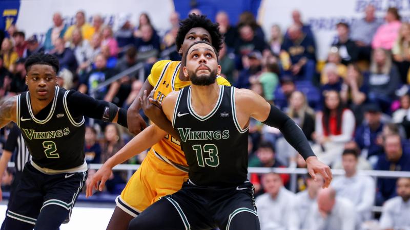 Tristan Enaruna (13)  and Jalin Rice (2) in action against Kent State.