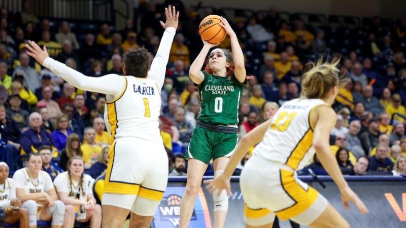 Woman shoots a basketball