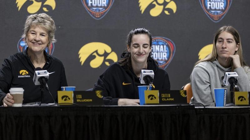 Iowa head coach Lisa Bluder and players Caitlin Clark and Kate Martin in a press conference ahead of their game against UConn.