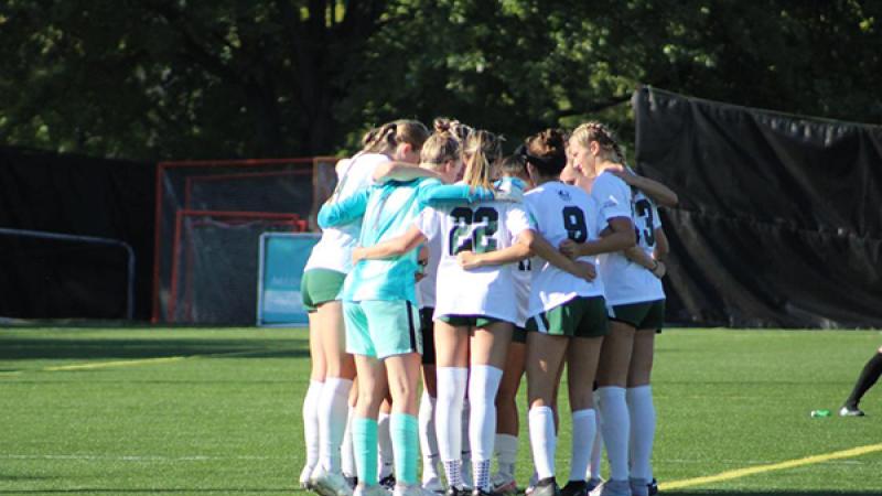 CSU women's soccer team huddled together