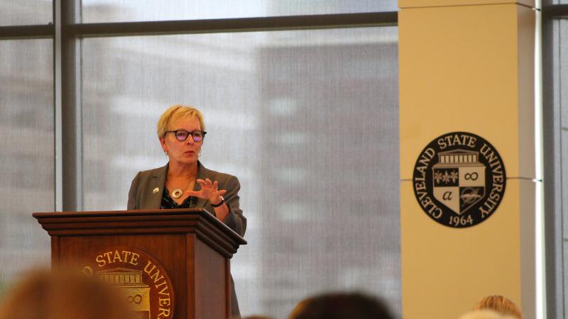 President Laura Bloomberg addresses faculty and staff at annual State of the University Address