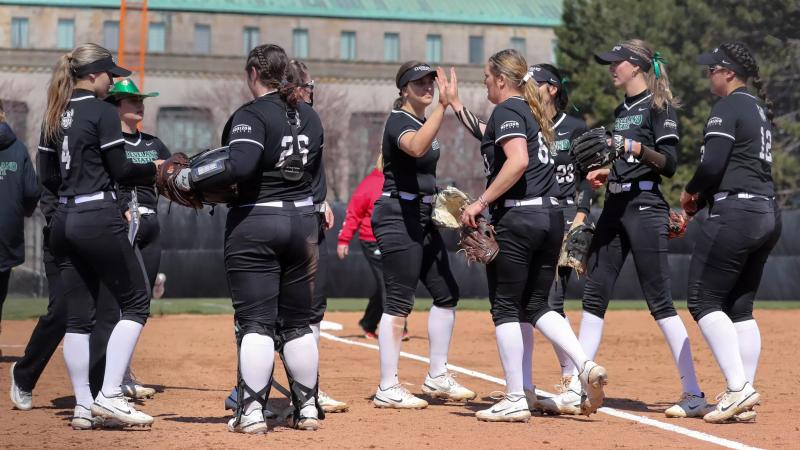 CSU Softball team high fives after game.