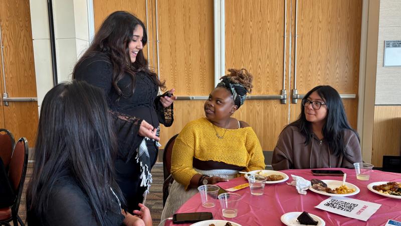  Ruby Darwish, a New Era Scholars member, passing out free nail appointment raffle tickets to attendees at the New Era Scholars Women’s Week: “Women United” event in Cleveland State Student Center Ballroom on Oct. 28, 2025.  