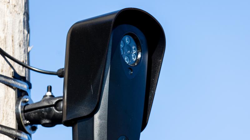  A Flock ALPR license plate reader camera fixed to a pole. 