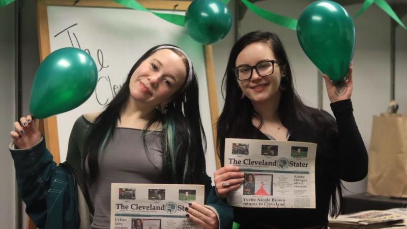 Picture credit: The Stater Newsroom Picture caption: Morgan Alten and Nicole Wlozek-Therens hold copies of the Cleveland Stater while celebrating the newspaper in the Stater newsroom on March 3, 2026.