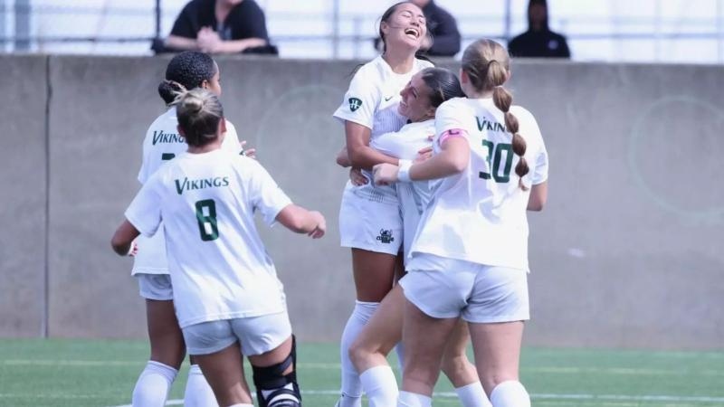 Cleveland State women’s soccer players celebrate with junior True Benshoff after she scored the game-winning goal in the Vikings’ 1-0 victory over Detroit Mercy on Oct. 10.
