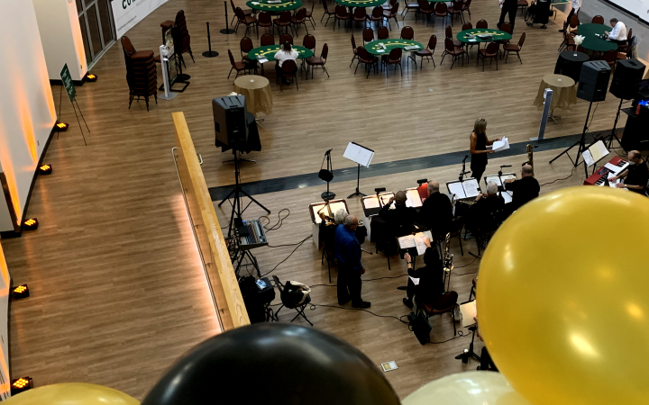 overhead view of Student Center Atrium as band warms up and casino dealers set up