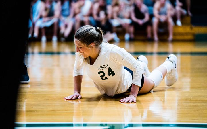 Volleyball player laying on ground