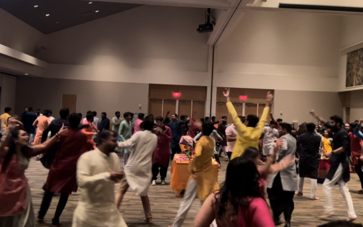 A group of people in Indian Ethnic attire dance together