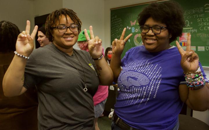 Ty Brown (left, she/they), a graphic design major, and Dale Jackson (right, they/he), a computer engineering major, pose for a picture at the Pride Mixer