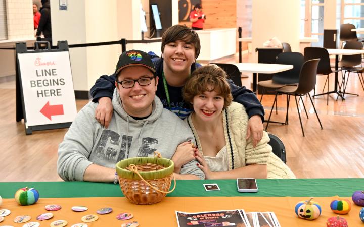 LGBTQ+ Student Services students, Joey Dzingeleski (Left), Gabrielle Murray (Right), and Axel McAvinue (Middle) could be found sharing their painted pumpkins and pride pins. 