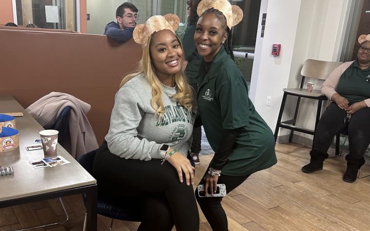 Two CSU students smile, wearing Build-A-Bear headbands.