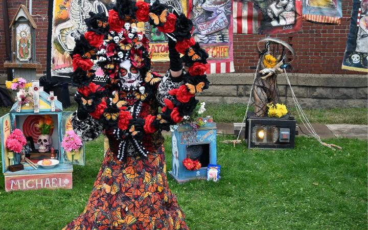 Skeleton lady surrounded by Altars of family and friends who have passed away, near the Cleveland Public Theatre, Nov. 4, 2023. (credit: Alex Martinez)
