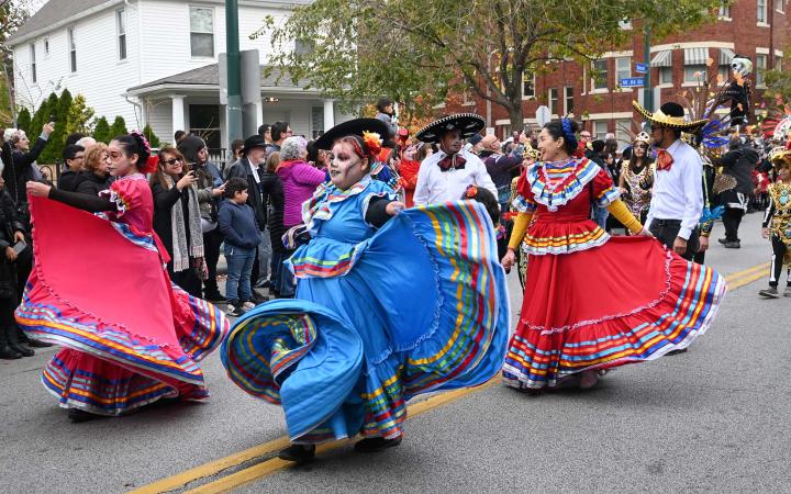 Women wearing folklorico dresses dance in Cleveland's Day of the Dead parade on Nov. 4, 2023. 