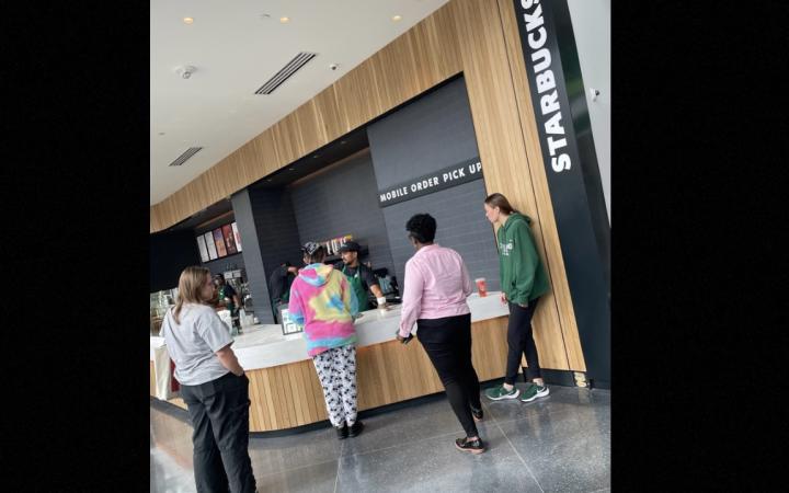 Customers waiting on their orders at the pick up station 