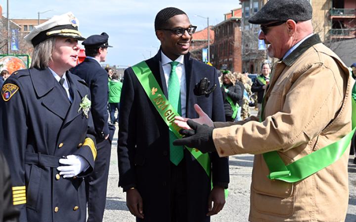 Dorothy A. Todd, Chief of Police, left, and Mayor Justin Bibb, center, talk to one of the parade participants, March 17, 2024. (credit: Alex Martinez)