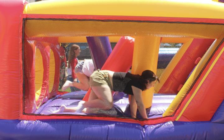 Students race in the bounce house obstacle course at CarniVike, May 1, at CSU. (credit: Koya Ball)