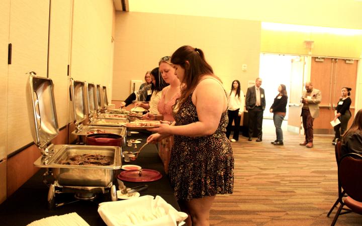 Attendees line up for a buffet style dinner. (credit: Koya Ball)