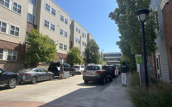 Unloading cars outside of the residence hall helping students move-in.