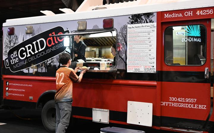 A customer orders Wilbur Tacos at the off the Griddle truck inside the I-X center, Sept. 21, 2024. (credit: Alex Martinez)