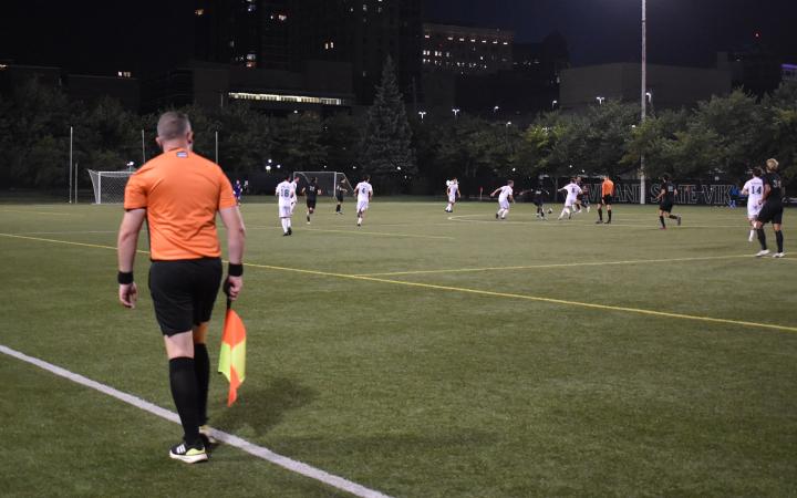 The referee’s assistant watches closely. (credit: Alex Martinez).