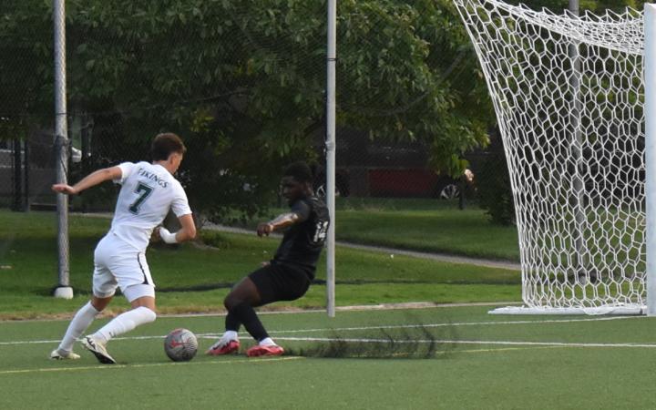 Chicago State defender Shaquan Reid (14) slides into the path of CSU's Marko Rimac (7), preventing a shot on goal. (credit: Alex Martinez).