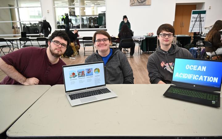 Aaron Barnes, left, Noah Haugen, center, and Cory Brotosky show off their video presentation on ocean acidification. (credit: Alex Martinez) 