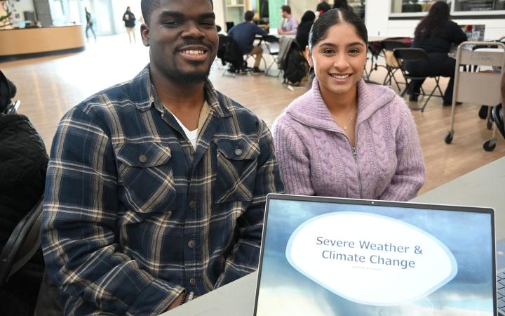 Suleiman, left, and Yesenia showcase their project on global heating. (credit: Alex Martinez) 