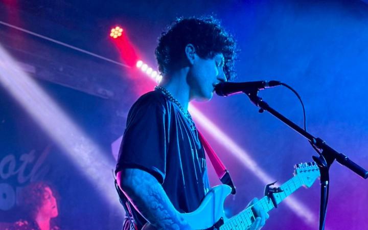 Photo credit: Grace Salter Photo caption: Alex Razayeski performs at local Cleveland venue, Brothers Lounge on June 28, 2024.