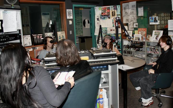 WCSB DJs Jack McLaughlin and Nicole Wloszek, backs to camera, hosted an interview on-air with Post Saga members Luke Mason, left, Danna O’Connor, center, and Jake Hirsch after their live performance, Sept. 27, 2025. 