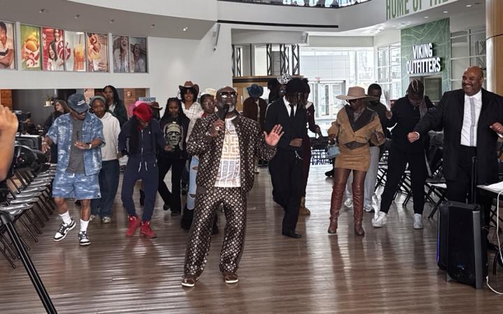 DJ Robert Johnson leading the line dance to “Boots on the Ground/Where Them Fans At?” at the end of the fashion show, Nov. 6, 2025. (credit: Anthony Reed)