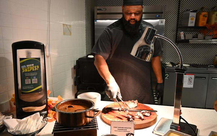 Chef preparing to serve attendees carved roasted tenderloin with garlic and rosemary. (credit: Alex Martinez)