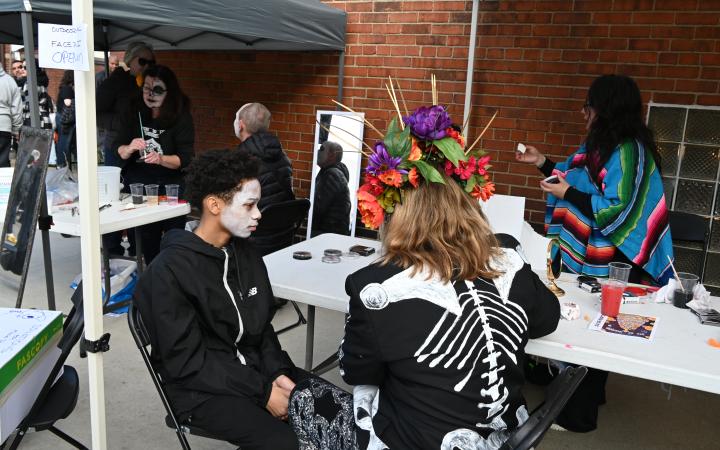 An event attendee gets a skull makeup, Nov.1, 2025. (credit: Alex Martinez)