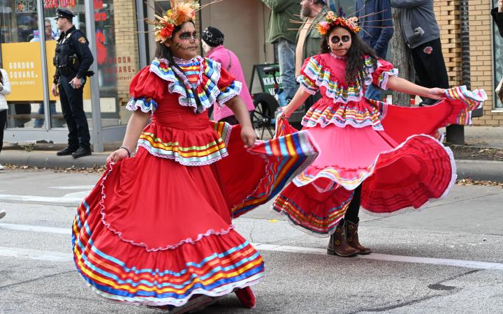 Women wearing folklórico dresses dance in Cleveland's Day of the Dead parade, Nov. 1, 2025. (credit: Alex Martinez)